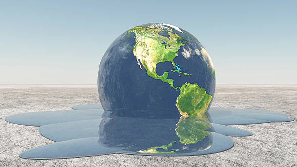 Representación conceptual de un globo terráqueo derritiéndose sobre arena desértica, simbolizando el calentamiento global.